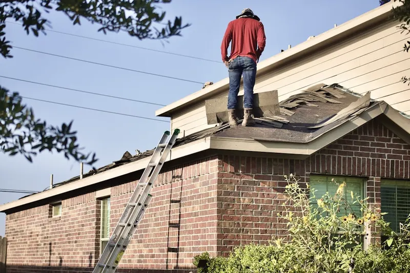 Professional roofer working on a residential roof in Donnelsville